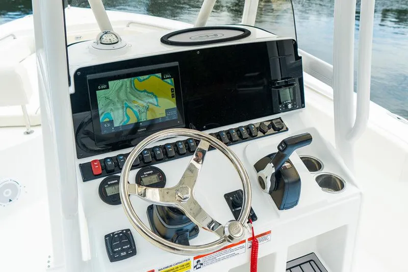 Slide: The Image of 2026 Sea Hunt Ultra 229 boat dashboard with navigation system and steering wheel. - 11