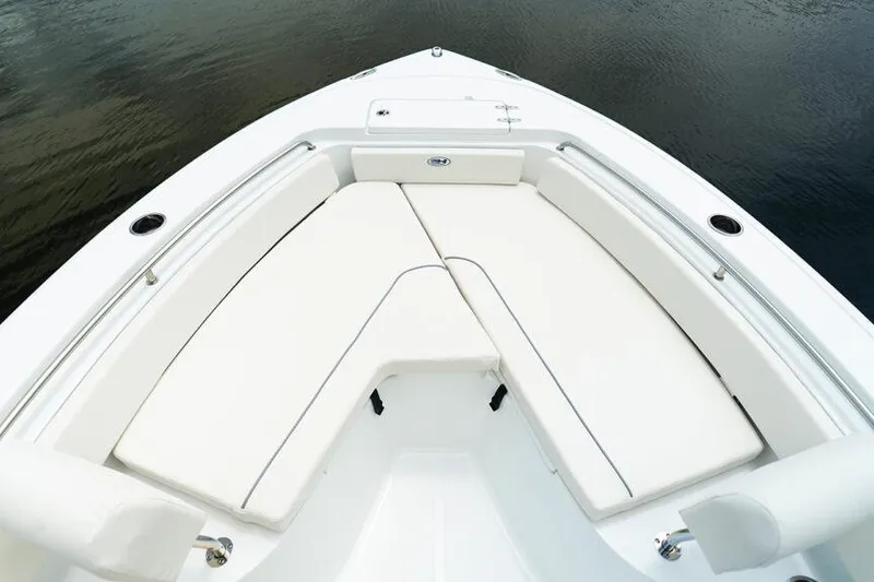 Slide: The Image of Bow seating area of 2026 Sea Hunt Ultra 229 boat with white cushions. - 12