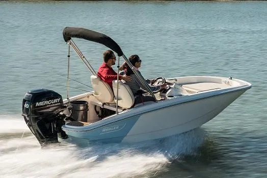 Slide: The Image of Manufacturer Provided Image: 2025 Boston Whaler 130 Super Sport boat cruising on water with Mercury engine. - 1