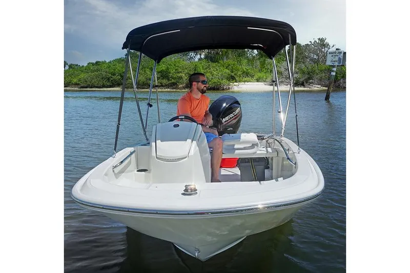 Slide: The Image of Manufacturer Provided Image: 2025 Boston Whaler 130 Super Sport boat on water, with canopy and driver. - 5