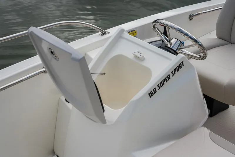 Slide: The Image of 2026 Boston Whaler 160 Super Sport boat interior with open storage compartment. - 8