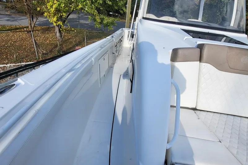 Slide: The Image of 2018 Edgewater 370CC boat interior with white seating and sleek design. - 14
