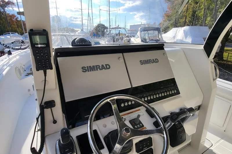 Slide: The Image of 2018 Edgewater 370CC boat helm with Simrad electronics and steering wheel. - 20
