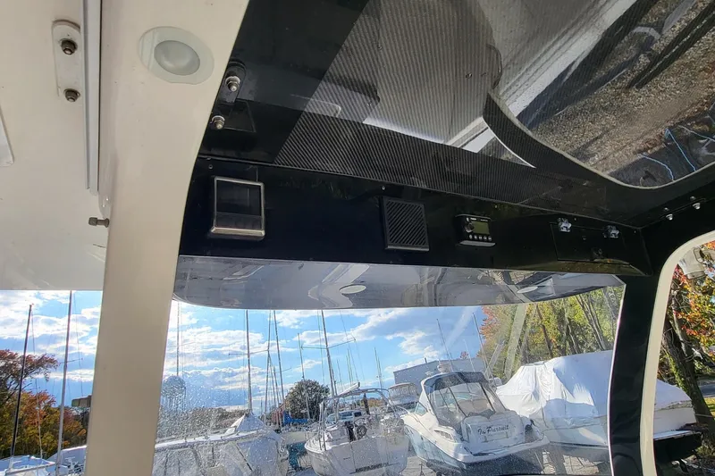 Slide: The Image of Interior view of a 2018 Edgewater 370CC boat with marina background. - 4