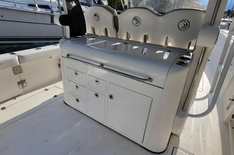 Slide: The Image of 2018 Edgewater 370CC boat interior with storage compartments and seating. - 7