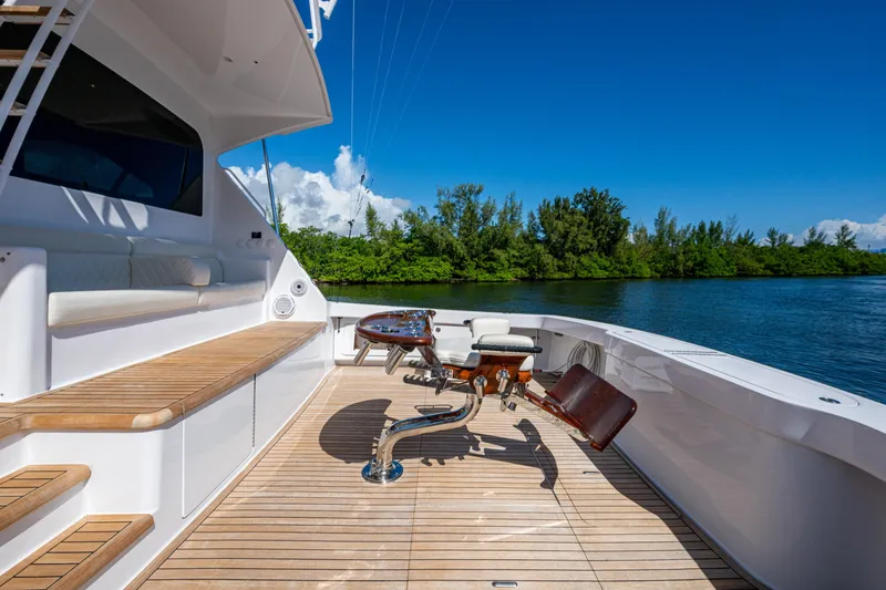 Slide: The Image of Luxurious 2008 Viking 74 Enclosed Bridge yacht deck with seating and scenic water view. - 14