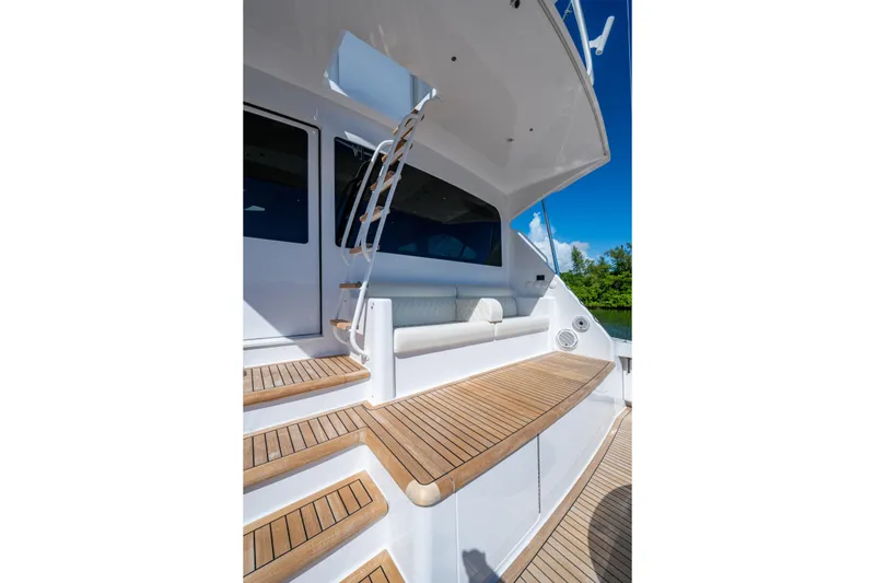 Slide: The Image of 2008 Viking 74 Enclosed Bridge yacht with teak steps and seating area. - 16