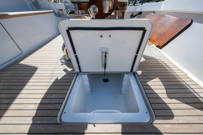 Slide: The Image of Open hatch on 2008 Viking 74 Enclosed Bridge yacht deck, showcasing storage space. - 18