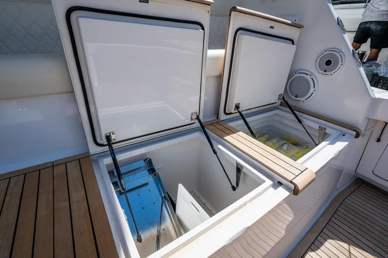 Slide: The Image of Open storage compartments on a 2008 Viking 74 Enclosed Bridge yacht deck. - 19