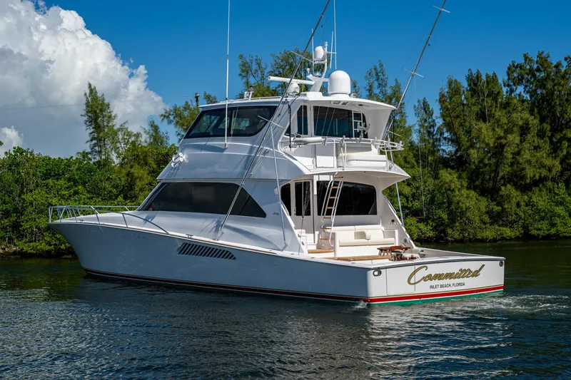 Slide: The Image of 2008 Viking 74 Enclosed Bridge yacht cruising on a serene waterway. - 2