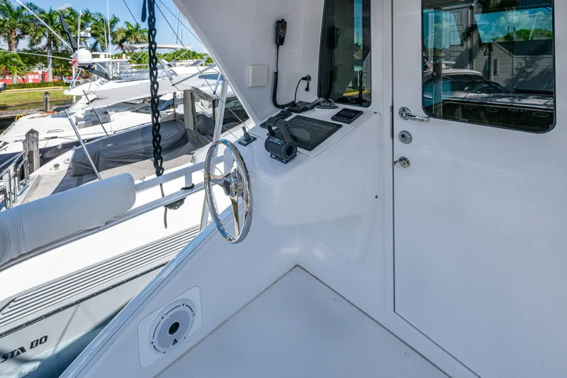 Slide: The Image of 2008 Viking 74 Enclosed Bridge yacht helm with steering wheel and navigation equipment. - 21