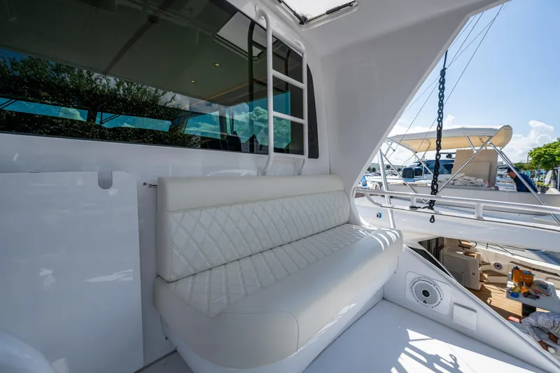 Slide: The Image of 2008 Viking 74 Enclosed Bridge yacht with white seating and marina view. - 24