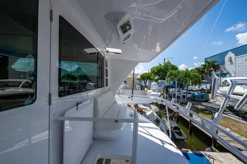 Slide: The Image of 2008 Viking 74 Enclosed Bridge yacht docked, showcasing sleek design and luxurious seating. - 26