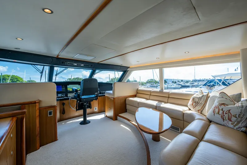 Slide: The Image of Luxurious interior of 2008 Viking 74 Enclosed Bridge yacht with plush seating and helm station. - 27