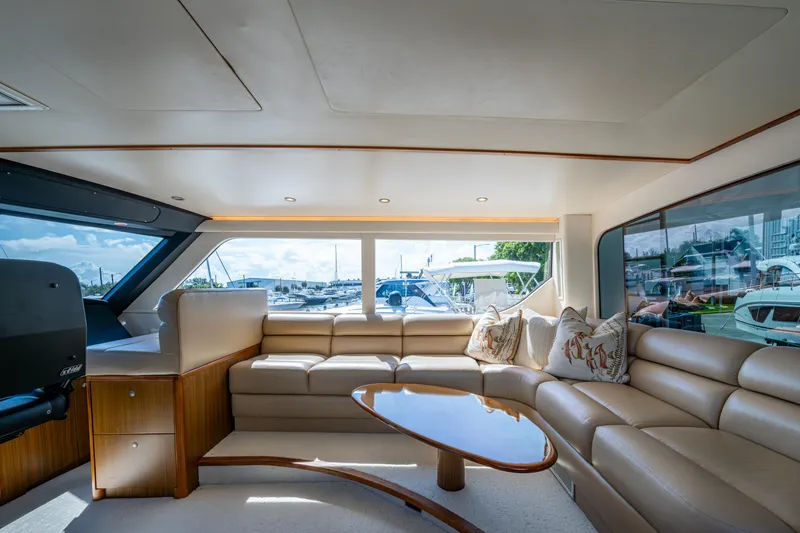 Slide: The Image of Luxurious interior of 2008 Viking 74 Enclosed Bridge yacht with plush seating and scenic windows. - 28