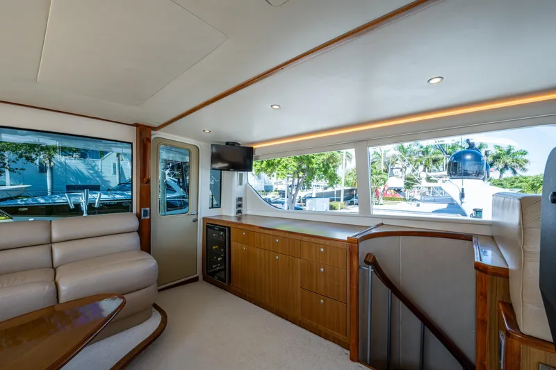 Slide: The Image of Luxurious interior of 2008 Viking 74 Enclosed Bridge yacht with elegant seating and panoramic windows. - 29