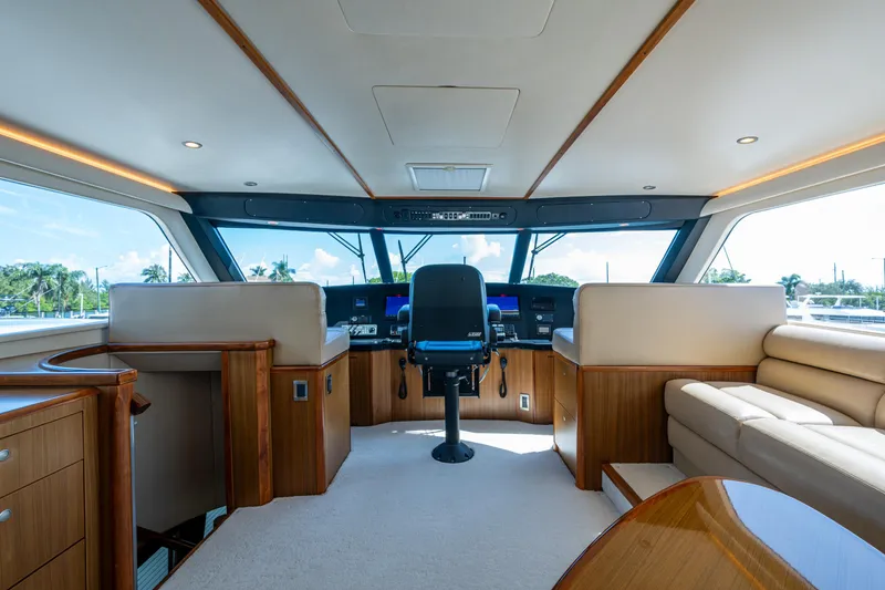Slide: The Image of Luxurious interior of 2008 Viking 74 Enclosed Bridge yacht with plush seating and helm. - 30