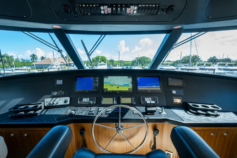 Slide: The Image of Cockpit of 2008 Viking 74 Enclosed Bridge yacht with navigation screens and controls. - 31