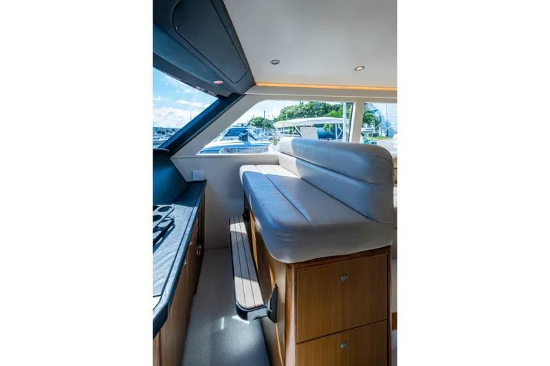 Slide: The Image of Interior of 2008 Viking 74 Enclosed Bridge yacht with seating and window view. - 35