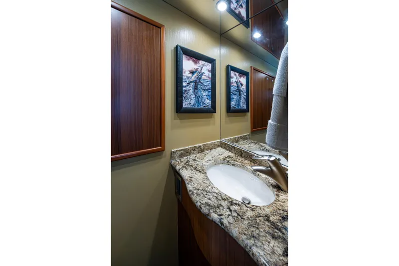 Slide: The Image of Luxurious bathroom in 2008 Viking 74 Enclosed Bridge yacht with granite countertop and elegant fixtures. - 38