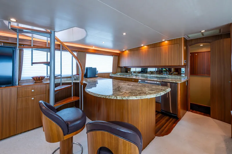 Slide: The Image of Luxurious interior of 2008 Viking 74 Enclosed Bridge yacht with modern kitchen and spiral staircase. - 39