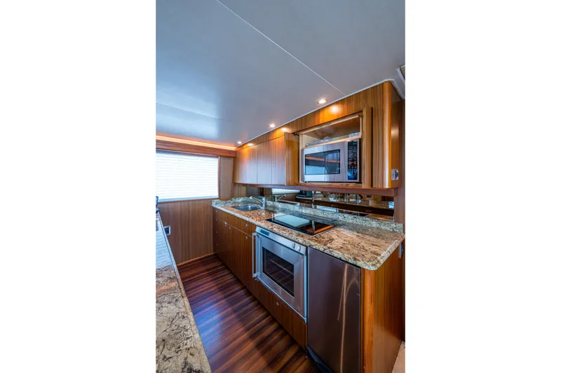 Slide: The Image of Luxurious kitchen interior of 2008 Viking 74 Enclosed Bridge yacht with modern appliances. - 40