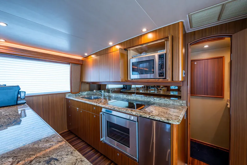 Slide: The Image of Luxurious kitchen interior of 2008 Viking 74 Enclosed Bridge yacht with modern appliances. - 42