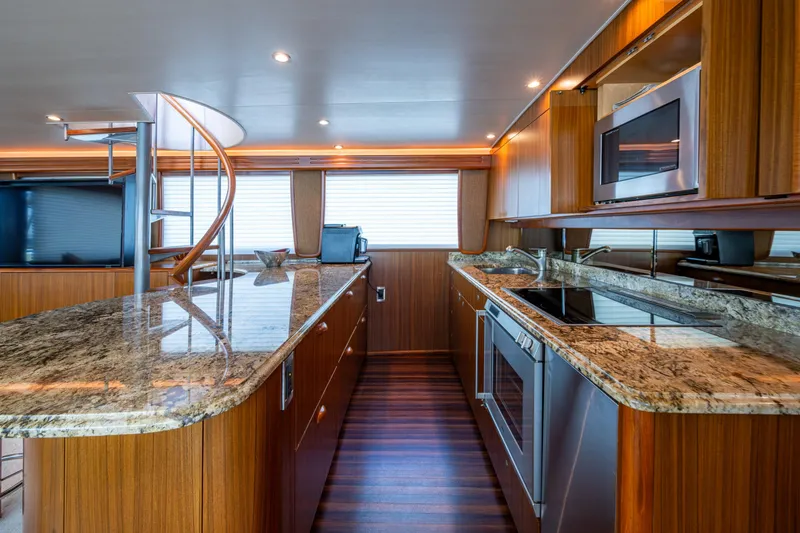 Slide: The Image of Luxurious kitchen interior of 2008 Viking 74 Enclosed Bridge yacht with granite countertops. - 43