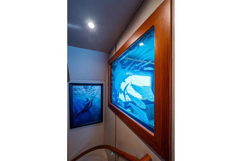Slide: The Image of Interior of 2008 Viking 74 Enclosed Bridge with marine-themed artwork and wood accents. - 44