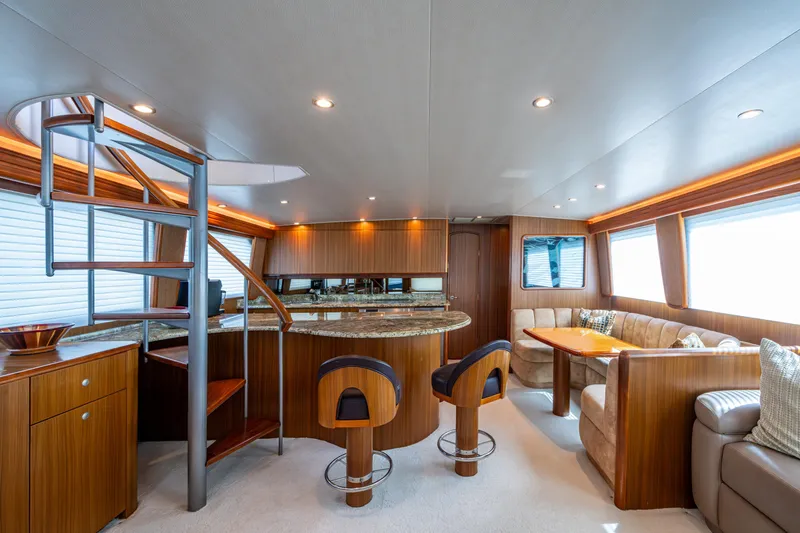 Slide: The Image of Luxurious interior of 2008 Viking 74 Enclosed Bridge yacht with modern furnishings and spiral staircase. - 46