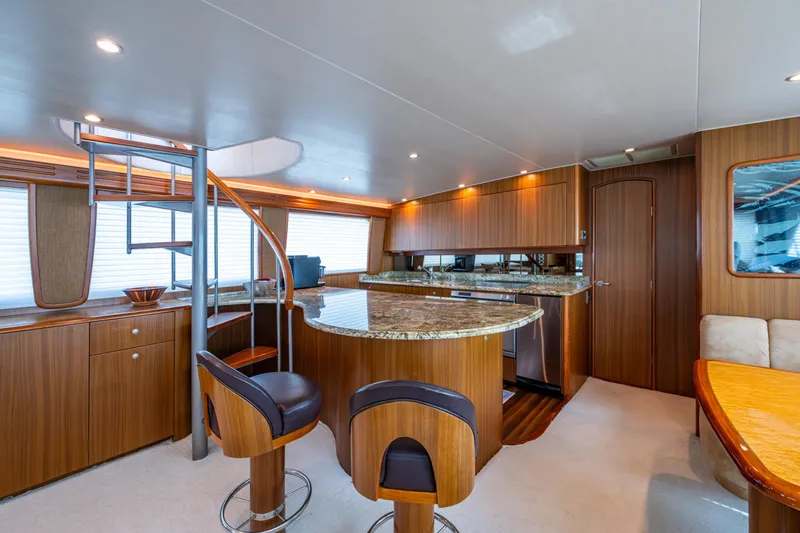 Slide: The Image of Luxurious interior of 2008 Viking 74 Enclosed Bridge yacht with modern kitchen and seating area. - 49