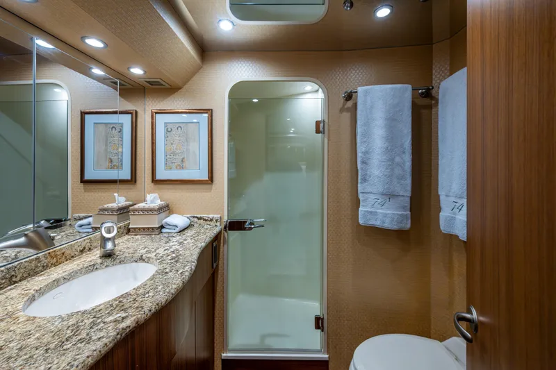 Slide: The Image of Luxurious bathroom in 2008 Viking 74 Enclosed Bridge yacht with granite countertop and elegant decor. - 55