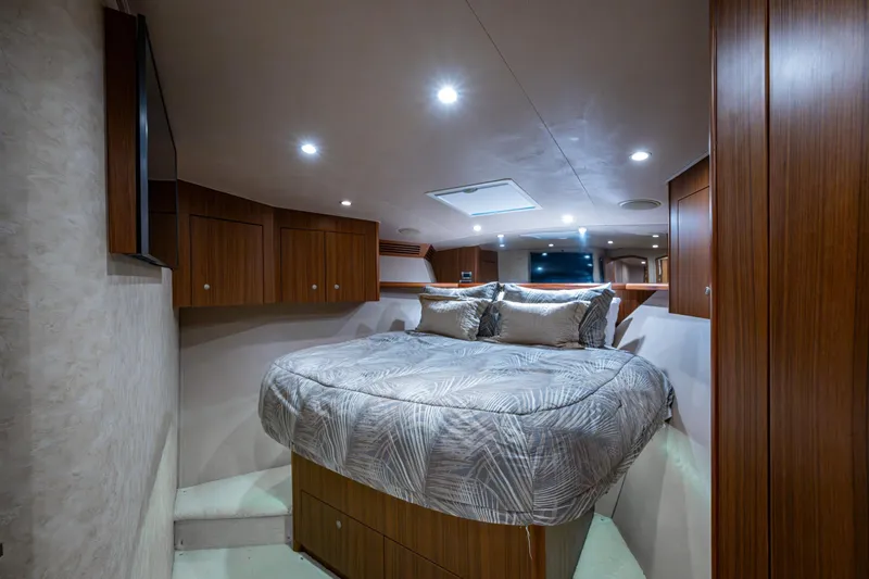 Slide: The Image of Luxurious bedroom interior of 2008 Viking 74 Enclosed Bridge yacht with modern wood finishes. - 56