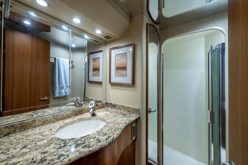Slide: The Image of Luxurious bathroom in 2008 Viking 74 Enclosed Bridge yacht with granite countertop and shower. - 57