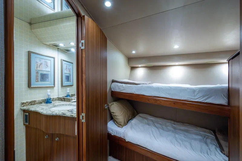 Slide: The Image of 2008 Viking 74 Enclosed Bridge yacht interior with bunk beds and bathroom. - 58