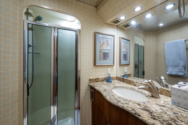 Slide: The Image of Luxurious bathroom in 2008 Viking 74 Enclosed Bridge yacht with granite countertop and shower. - 59