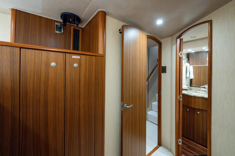 Slide: The Image of Interior of 2008 Viking 74 Enclosed Bridge yacht with wooden cabinetry and stairs. - 62