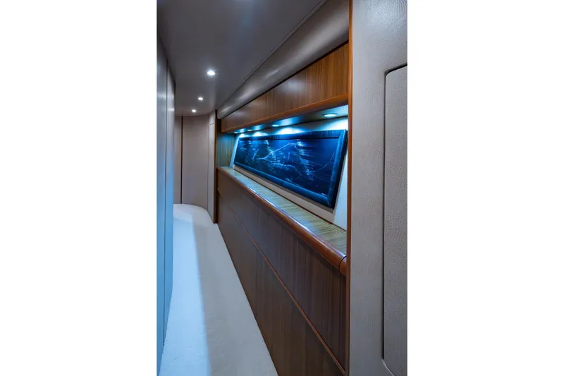 Slide: The Image of Luxurious hallway inside 2008 Viking 74 Enclosed Bridge yacht, featuring elegant wood paneling and ambient lighting. - 64