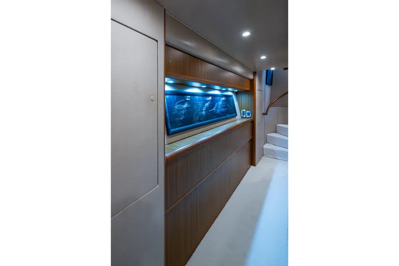 Slide: The Image of Interior of 2008 Viking 74 Enclosed Bridge yacht with wood paneling and illuminated display. - 65