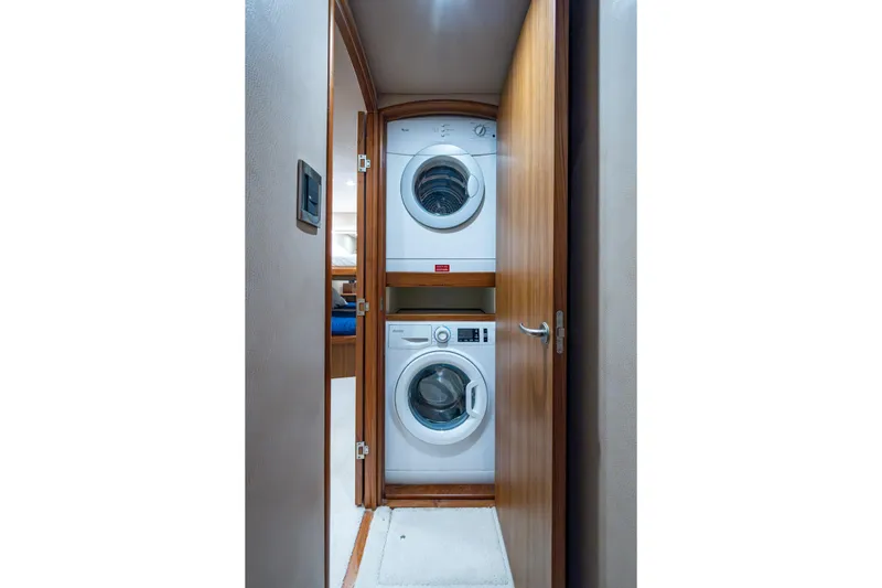 Slide: The Image of Stacked washer and dryer in 2008 Viking 74 Enclosed Bridge yacht interior. - 66