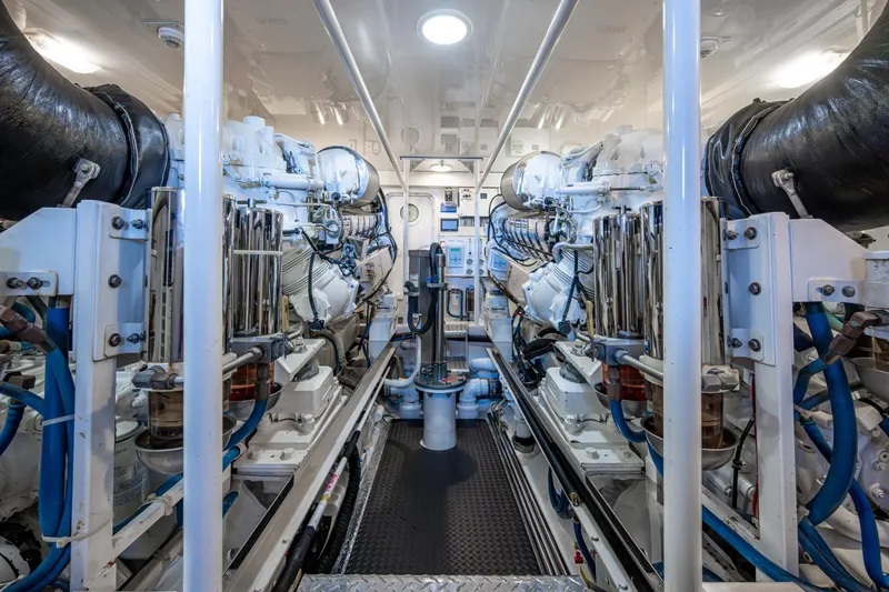 Slide: The Image of Engine room of 2008 Viking 74 Enclosed Bridge yacht, showcasing dual engines and mechanical systems. - 67
