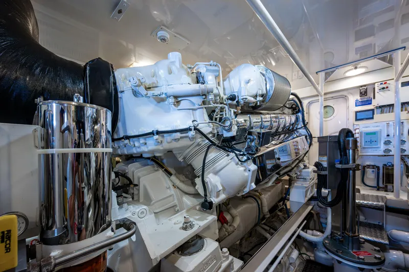 Slide: The Image of Engine room of 2008 Viking 74 Enclosed Bridge yacht, showcasing advanced machinery and controls. - 68