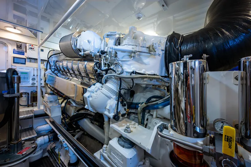 Slide: The Image of Engine room of 2008 Viking 74 Enclosed Bridge yacht, showcasing detailed machinery and components. - 69