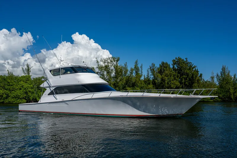 Slide: The Image of 2008 Viking 74 Enclosed Bridge yacht on calm water, clear sky background. - 7
