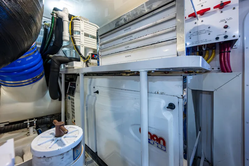 Slide: The Image of Engine room of 2008 Viking 74 Enclosed Bridge yacht, featuring mechanical and electrical systems. - 70