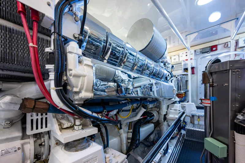 Slide: The Image of Engine room of 2008 Viking 74 Enclosed Bridge yacht, showcasing intricate machinery and components. - 73