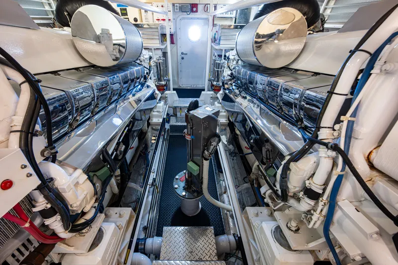Slide: The Image of Engine room of 2008 Viking 74 Enclosed Bridge yacht, showcasing dual engines and machinery. - 75