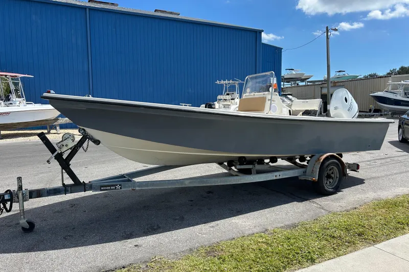 The Image of 1997 Sea Pro SV2100CC Bay Boat on trailer, parked outdoors under blue sky. - 1