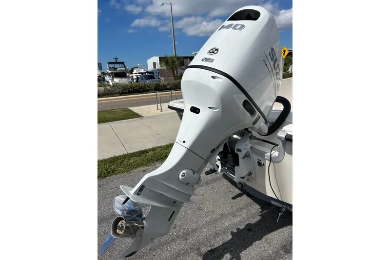 Slide: The Image of Outboard motor on a 1997 Sea Pro SV2100CC Bay Boat, parked near a marina. - 4