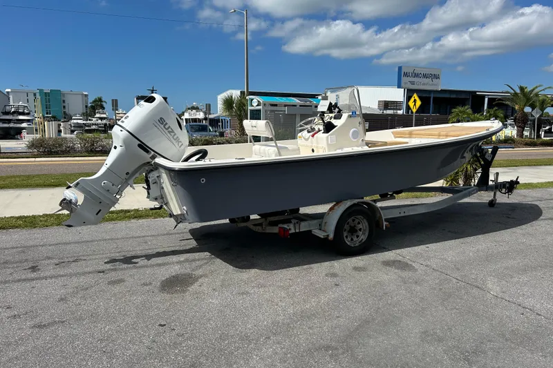 Slide: The Image of 1997 Sea Pro SV2100CC Bay Boat on trailer, parked near marina under blue sky. - 5